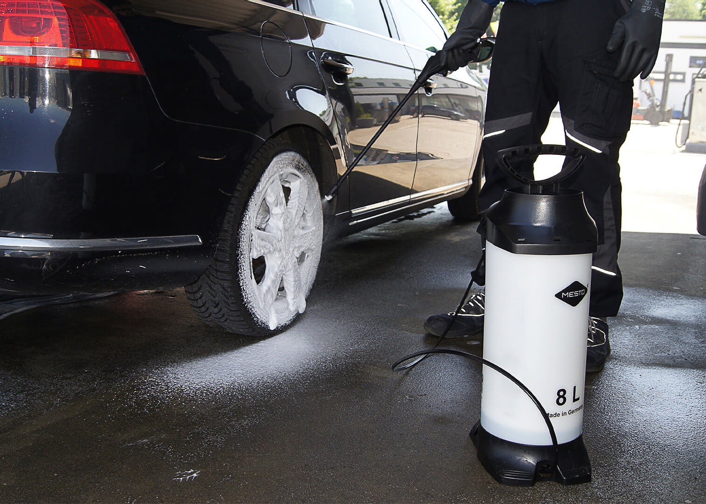 photo showing our 8 litre foaming sprayer being used to apply a cleaning solution to the wheels of a car