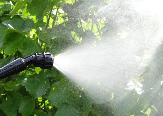 photo of four hole nozzle spraying liquid and showing the atomization of the liquid droplets which makes the sprayer nozzle ideal for horticulture spraying