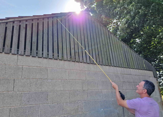 photo showing our brass 2 metre lance being used to spray timber panelling on a garden shed.