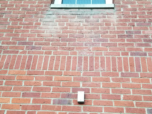cleaning a brick wall and removing atmospheric staining