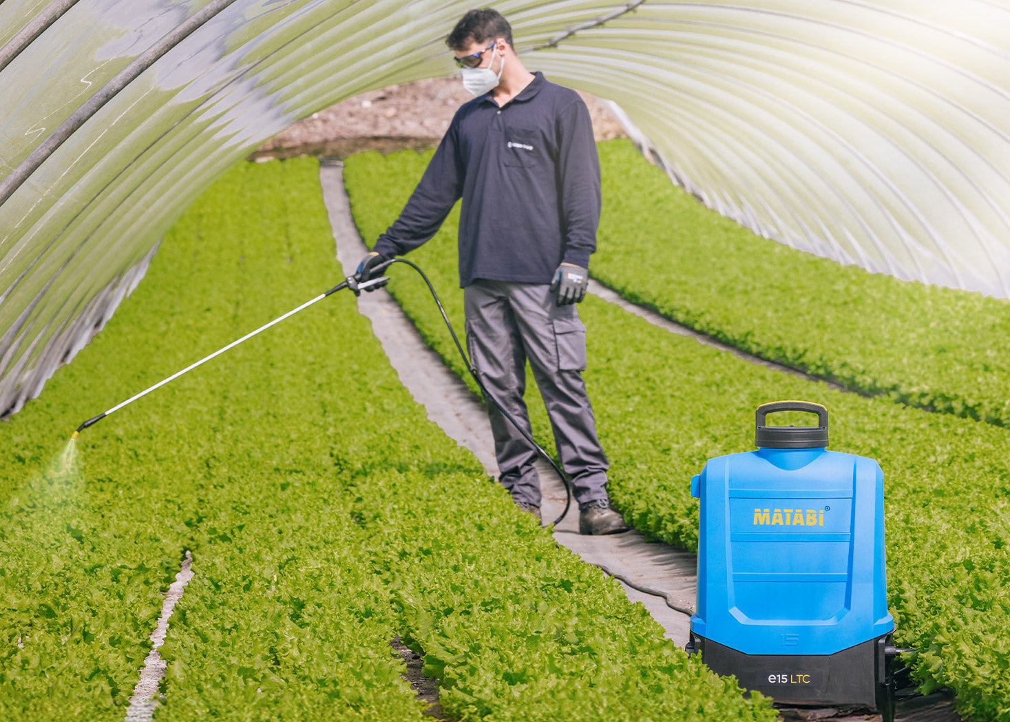 electric backpack sprayer being used with  a hose extension