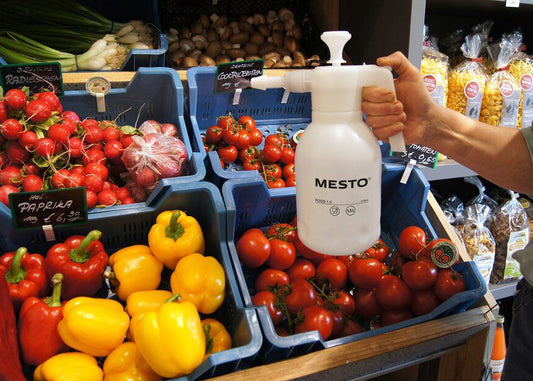 spraying vegetables with water to keep them fresh