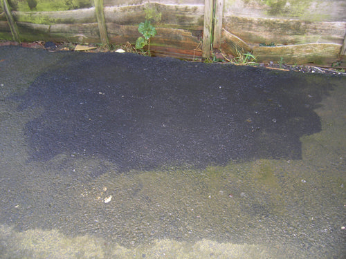 photo showing an area of tarmac after being cleaned with Batifast. It is easy to see how the growth & staining has been removed.