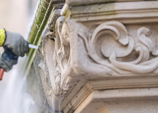 the delicate cleaning of stone on the facade of a building